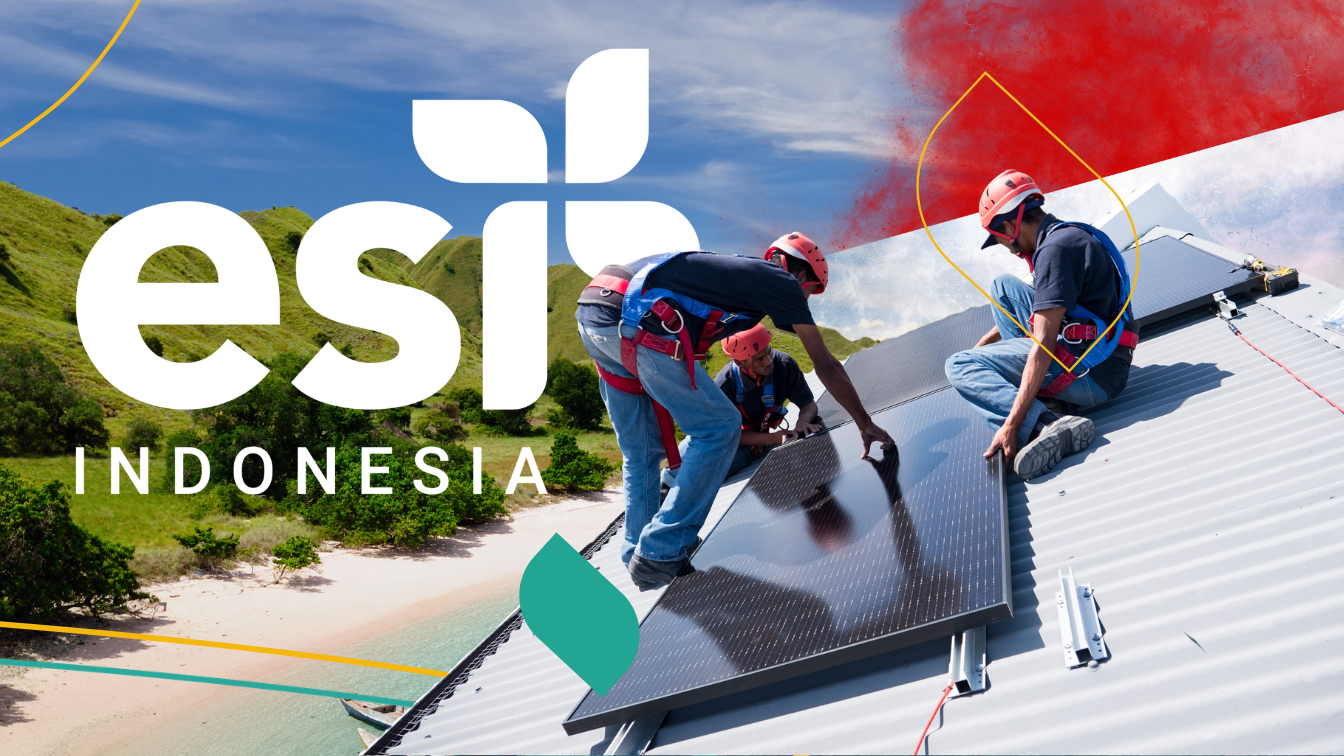Energy technician installing solar panels on a small business rooftop in Indonesia
